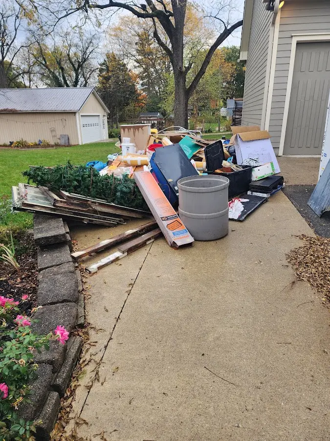 Dumpster being loaded with debris for Commercial Dumpster Rental in Morrisville